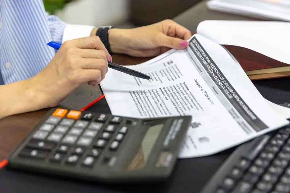 Financial documents with a calculator, illustrating the kind of source records fiscal calendars are compiled from.